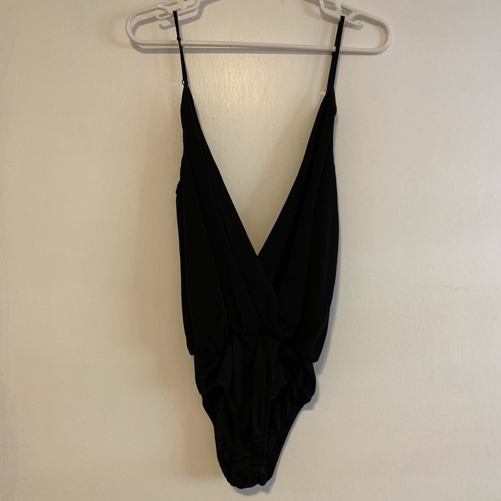 NWOT black cross body suit